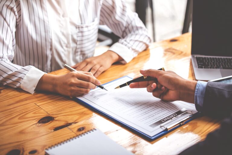 business people negotiating contracts with the documents on the table and sign the contract