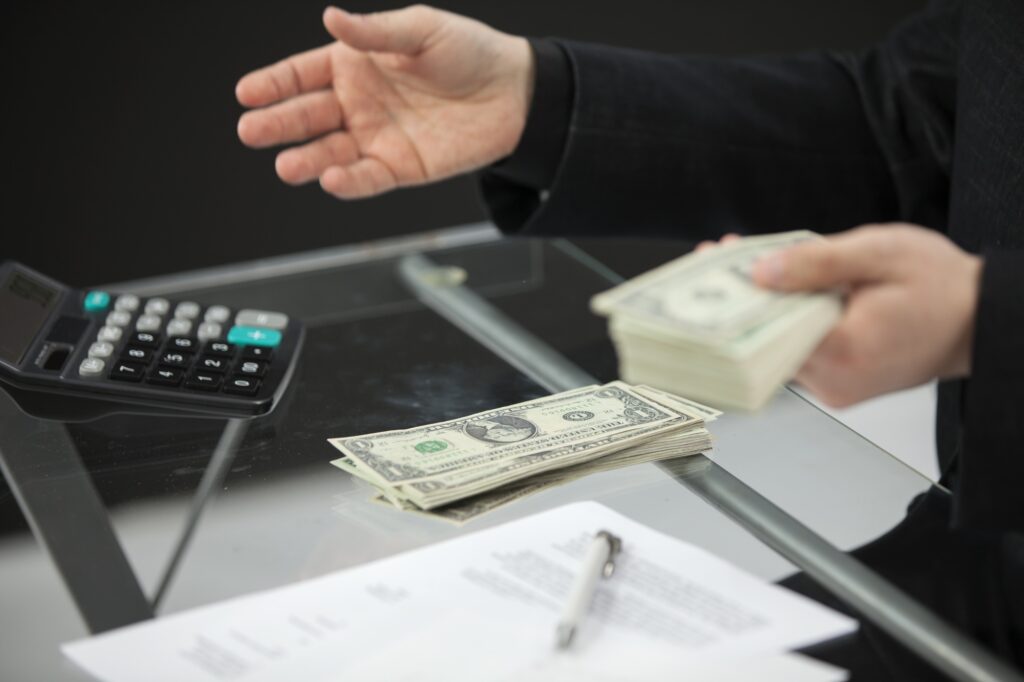 Counting the money behind his desk
